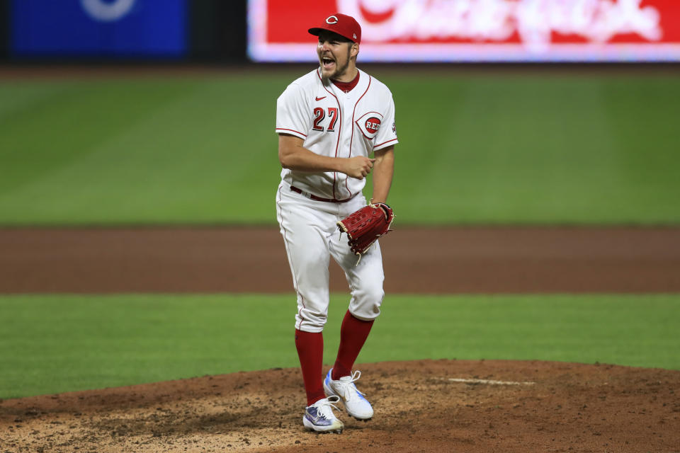 Cincinnati Reds' Trevor Bauer reacts after striking out Milwaukee Brewers' Christian Yelich in the eighth inning during a baseball game in Cincinnati, Wednesday, Sept. 23, 2020. The Reds won 6-1. (AP Photo/Aaron Doster)