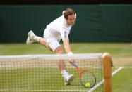 Great Britain's Andy Murray in action against Poland's Jerzy Janowicz during day eleven of the Wimbledon Championships at The All England Lawn Tennis and Croquet Club, Wimbledon.