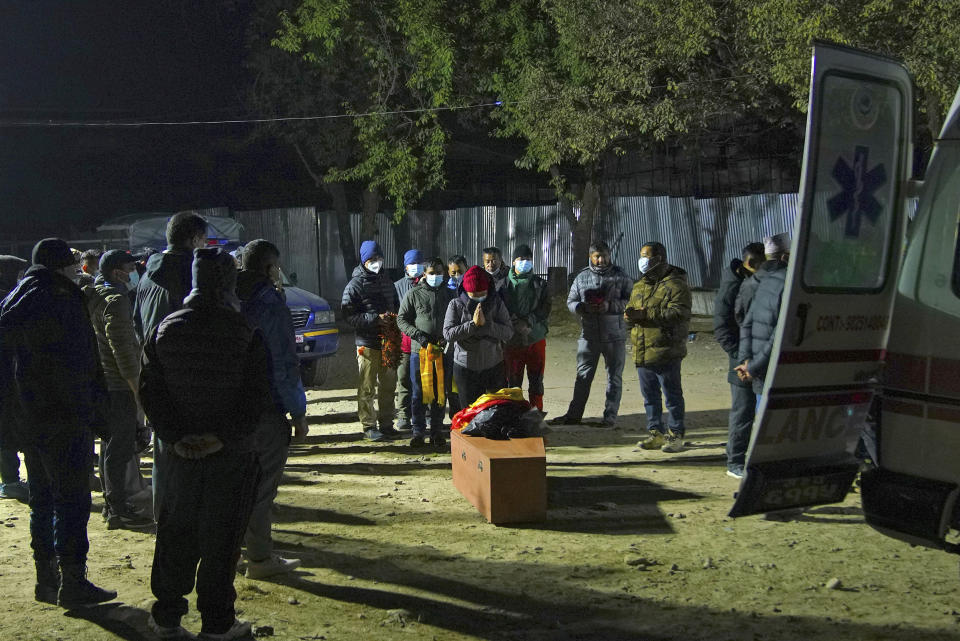 Family members receive the body of a victim of Sunday's plane crash in Pokhara, Nepal, Monday, Jan 16, 2023. At least 69 of the 72 people aboard were killed, and officials believe the three missing are also dead. Rescuers combed through the debris, scattered down a 300-meter-deep (984-foot-deep) gorge, for them. (AP Photo/Yunish Gurung)