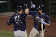 Tampa Bay Rays' Mike Zunino, left, celebrates his home run with Willy Adames during the seventh inning of the team's baseball game against the Los Angeles Angels, Thursday, May 6, 2021, in Anaheim, Calif. (AP Photo/Jae C. Hong)