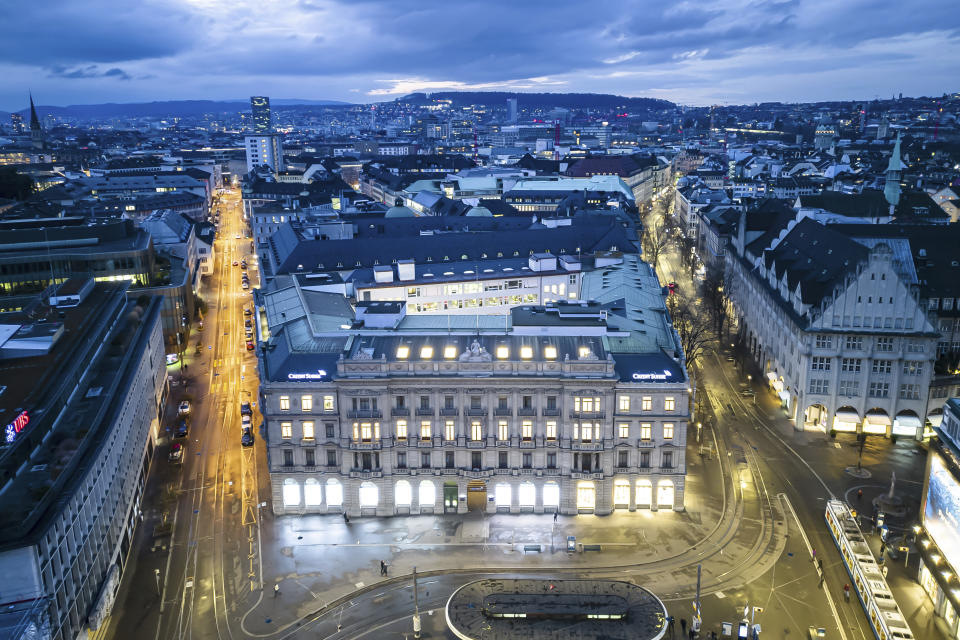 An aerial view of the headquarters of the Swiss banks Credit Suisse, center, and UBS, left, at Paradeplatz in Zurich, Switzerland, Sunday March 19, 2023. Banking giant UBS is acquiring its smaller rival Credit Suisse in an effort to avoid further market-shaking turmoil in global banking, Swiss President Alain Berset announced on Sunday. Sunday’s news conference by the Federal Council, the seven-member governing body that includes Berset, follows the collapse of two large U.S. banks last week that spurred a frantic, broad response from the U.S. government to prevent any further bank panics. (Michael Buholzer/Keystone via AP)