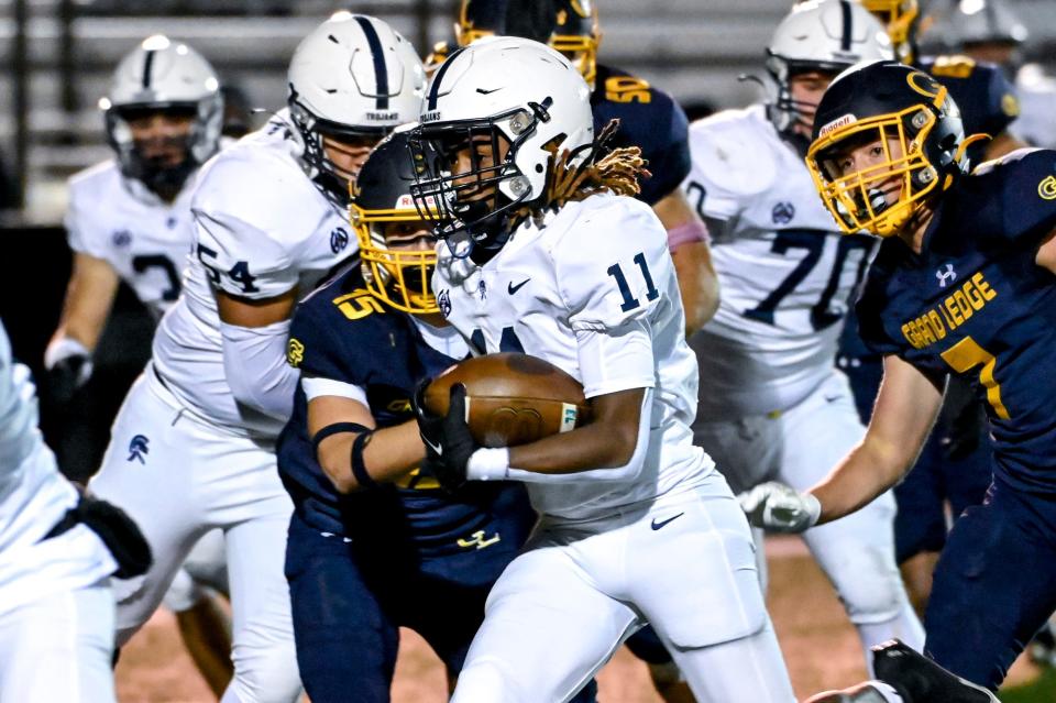 East Lansing's Dwataye Sams Jr. runs for a gain against Grand Ledge during the fourth quarter on Friday, Oct. 20, 2023, at Grand Ledge High School.