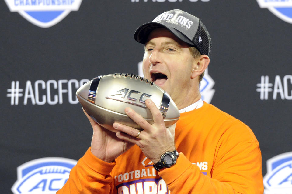 Clemson head coach Dabo Swinney celebrates with the trophy following the Atlantic Coast Conference championship NCAA college football game against Virginia in Charlotte, N.C., Saturday, Dec. 7, 2019. Clemson won 62-17. (AP Photo/Mike McCarn)