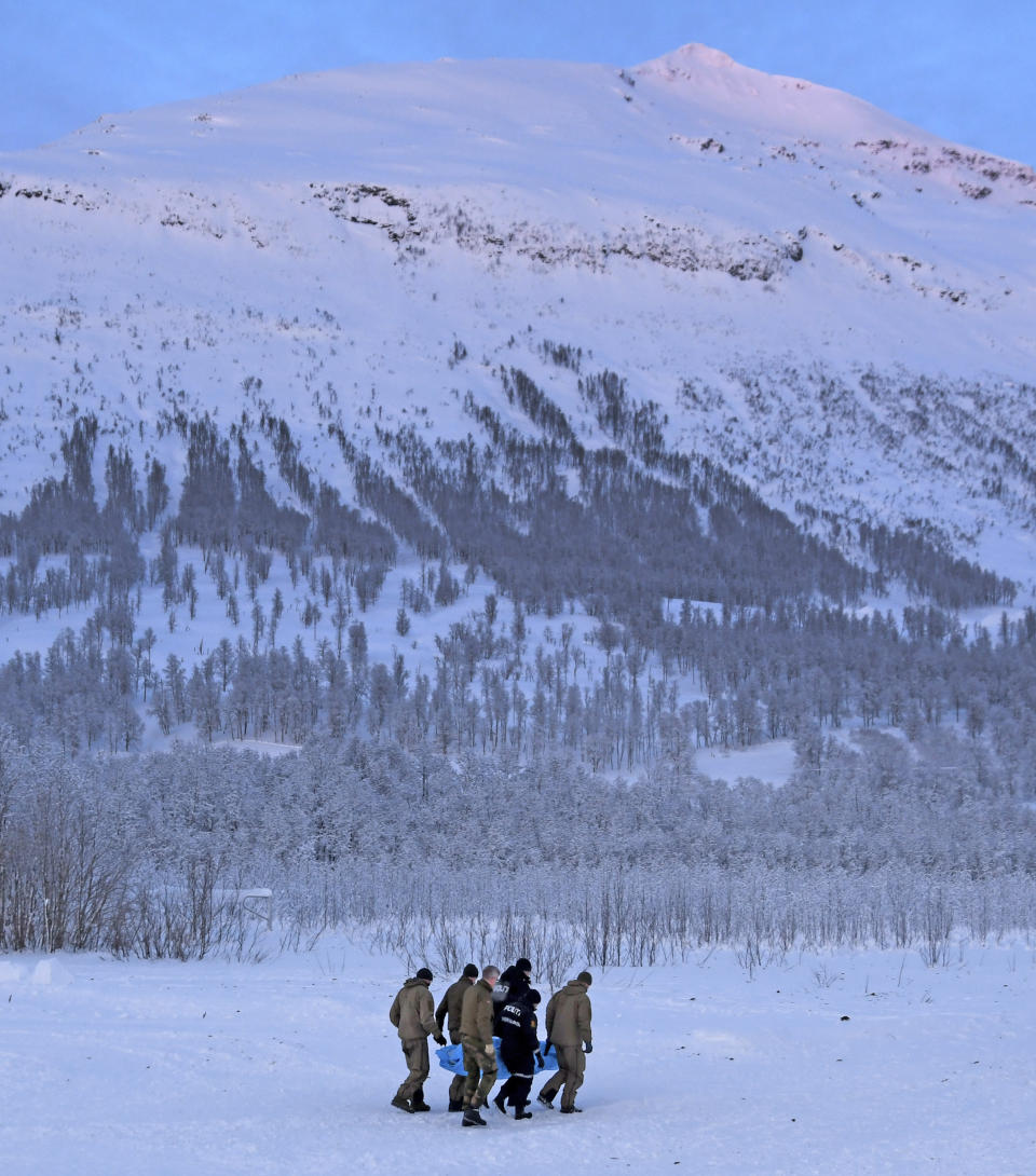 Rescue workers carry a victim after a 300-meter (990-foot) wide avalanche that hit the Tamok Valley, near the northern city of Tromsoe, Norway, Thursday Jan. 17, 2019. Norwegian police say they have located the bodies of three ski tourists that were hit by an avalanche in northern Norway on January 2, and a police spokesman said Wednesday they would continue search efforts for the fourth victim weather permitting. (Rune Stoltz Bertinussen/NTB Scanpix)