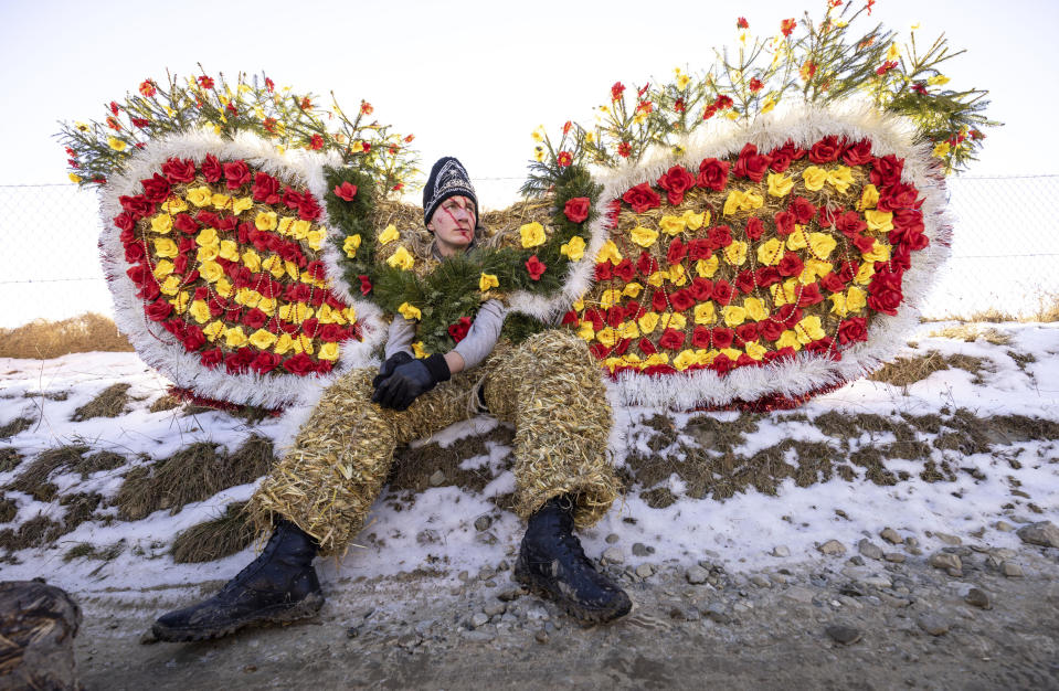 A villager, dressed in a traditional bear costume, celebrates the Malanka festival in the village of Krasnoilsk, Ukraine, Friday, Jan. 14, 2022. Dressed as goats, bears, oxen and cranes, many Ukrainians rang in the new year last week in the colorful rituals of the Malanka holiday. Malanka, which draws on pagan folk tales, marks the new year according to the Julian calendar, meaning it falls on Jan. 13-14. In the festivities, celebrants go from house to house, where the dwellers offer them food. (AP Photo/Ethan Swope)