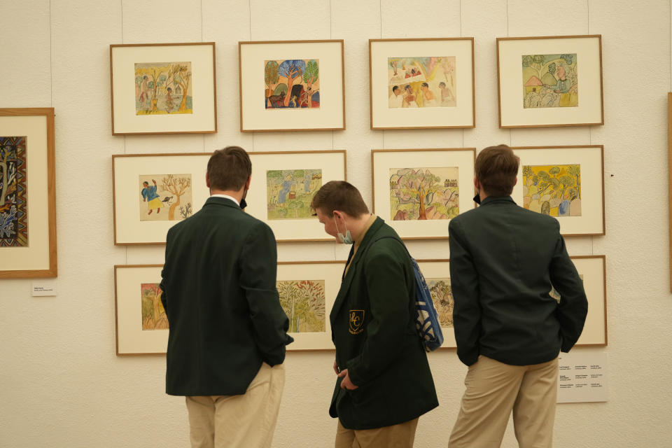 Schoolchildren look at paintings done in the 1940s and 1950s by young Black students at Cyrene Mission School at the National Gallery of Zimbabwe, Wednesday July 27, 2022. The paintings are part of a historic exhibit, "The Stars are Bright," now showing in Zimbabwe for the first time since the collection left the country more than 70 years ago. (AP Photo/Tsvangirayi Mukwazhi)