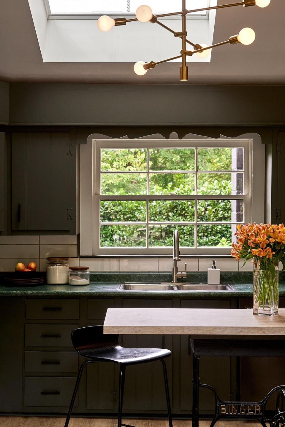 Kitchen with dark walls and sink next to a window