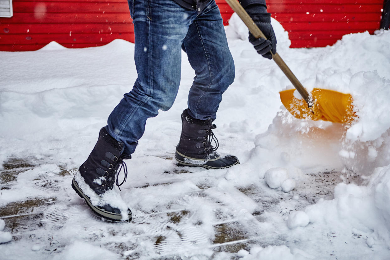 Man shovelling snow off his driveway