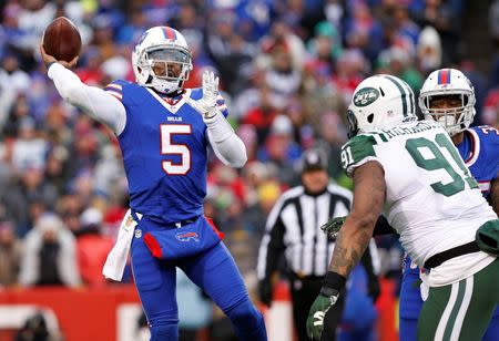 Jan 3, 2016; Orchard Park, NY, USA; Buffalo Bills quarterback Tyrod Taylor (5) throws a pass under pressure by New York Jets defensive end Sheldon Richardson (91) during the second half at Ralph Wilson Stadium. Mandatory Credit: Kevin Hoffman-USA TODAY Sports