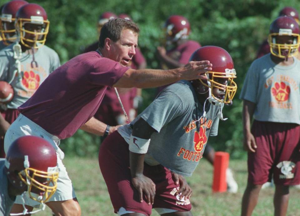 8/4/98. Coach Tommy Knotts, left, gives pointers to running back, Fred Staton, right, during team practice at West Charlotte High School.
