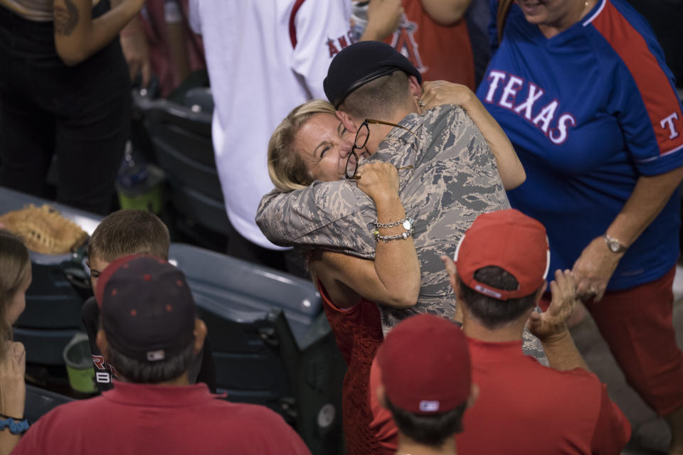 <p>Airman Basic Brock Bukosky of the U.S. Air Force poses hugs his mother Debbie Buksoky after surprising her by returning home from a 6-month deployment during the game between the Texas Rangers and the Los Angeles Angels of Anaheim at Angel Stadium of Anaheim on July 19, 2016 in Anaheim, California. (Photo by Josh Barber/Angels Baseball LP/Getty Images) </p>
