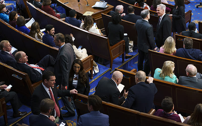 Rep. Andrew Clyde (R-Ga.) speaks with Rep. Kevin McCarthy (R-Calif.), top right, during the second day of the 118th session of Congress on Jan. 4 as the House attempts to elect a Speaker. <em>Greg Nash</em>
