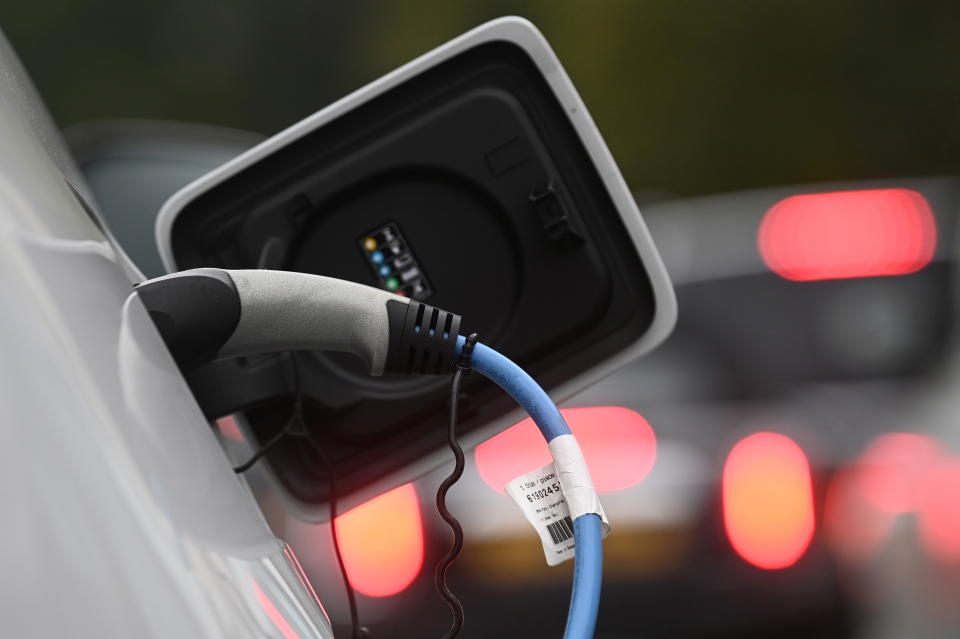 An electric car is charged at a roadside EV charge point, London, October 19, 2021. REUTERS/Toby Melville