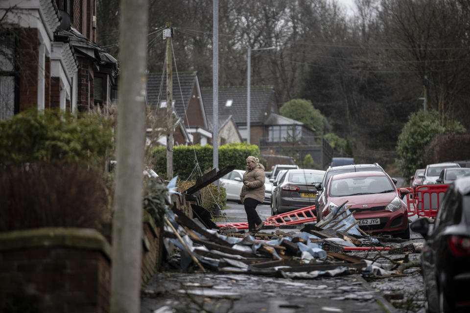 STALYBRIDGE, ENGLAND - DECEMBER 28: Resident Rebecca Saycell waits outside her house after the roof was ripped off in the aftermath of a tornado on December 28, 2023 in Stalybridge, England. Houses in the Tameside area of Greater Manchester have been damaged by a localised tornado during Storm Gerrit. Police declared a major incident last night as roofs were torn off the houses and trees uprooted, but no reported injuries. (Photo by Ryan Jenkins/Getty Images)