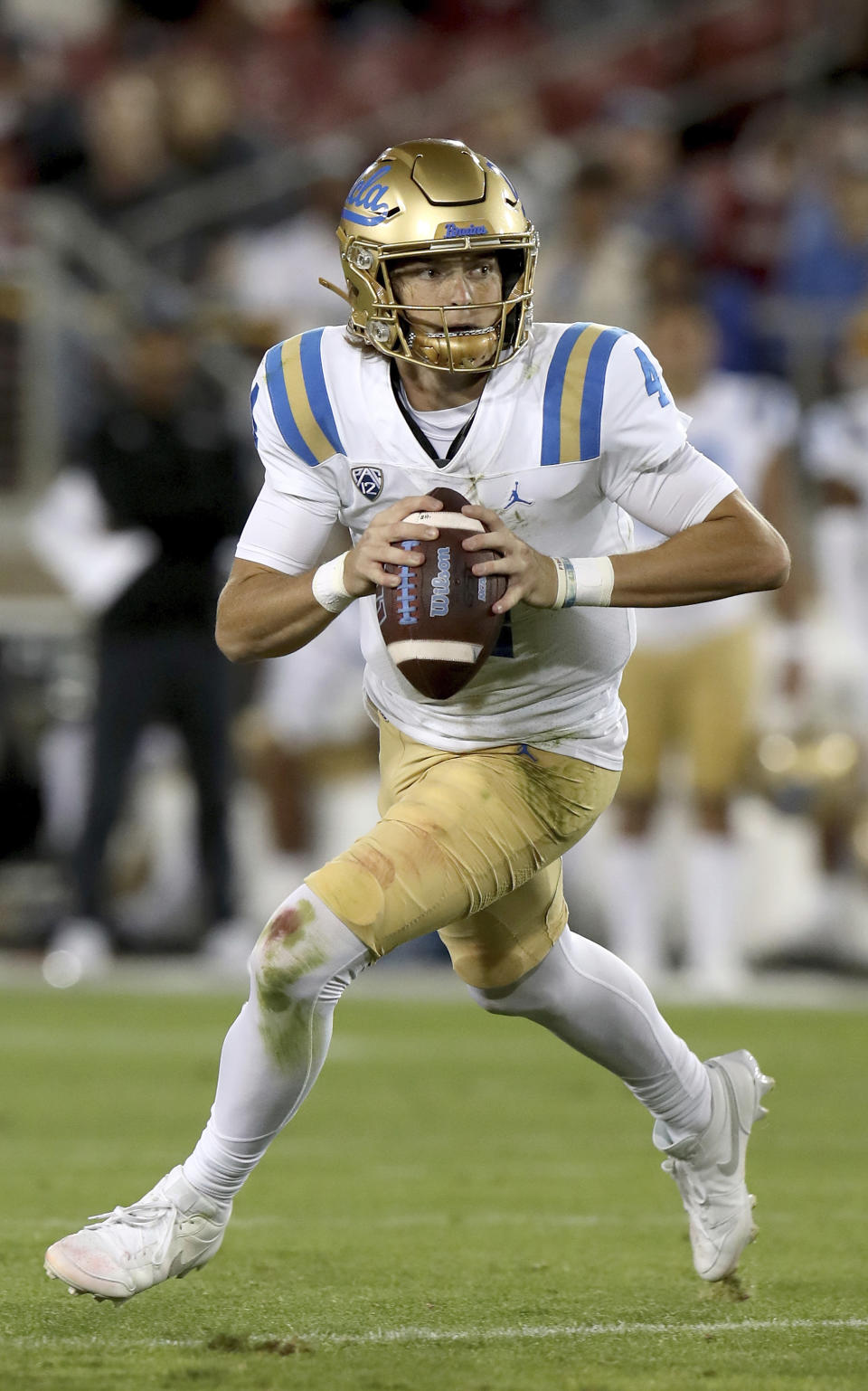 UCLA quarterback Ethan Garbers (4) scrambles during an NCAA college football game against Stanford, Saturday, Oct. 21, 2023, in Stanford, Calif. (AP Photo/Scot Tucker)