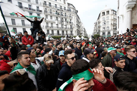 People carry national flags during a protest calling on President Abdelaziz Bouteflika to quit, in Algiers, Algeria March 26, 2019. REUTERS/Ramzi Boudina