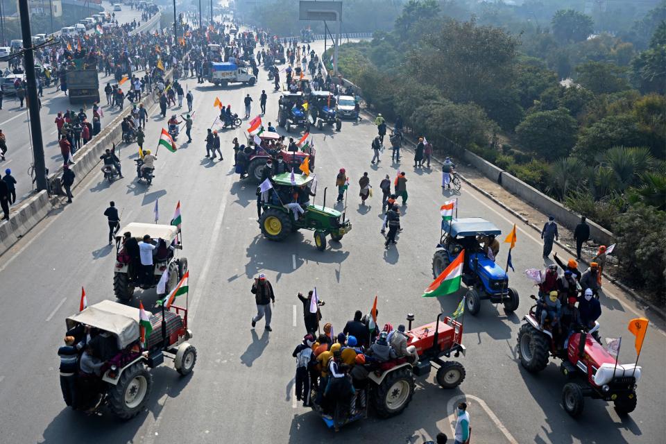 Farmers take part in a tractor rally as they continue to demonstrate against the central government's recent agricultural reforms in New Delhi on January 26, 2021. (Photo by Money SHARMA / AFP) (Photo by MONEY SHARMA/AFP via Getty Images)