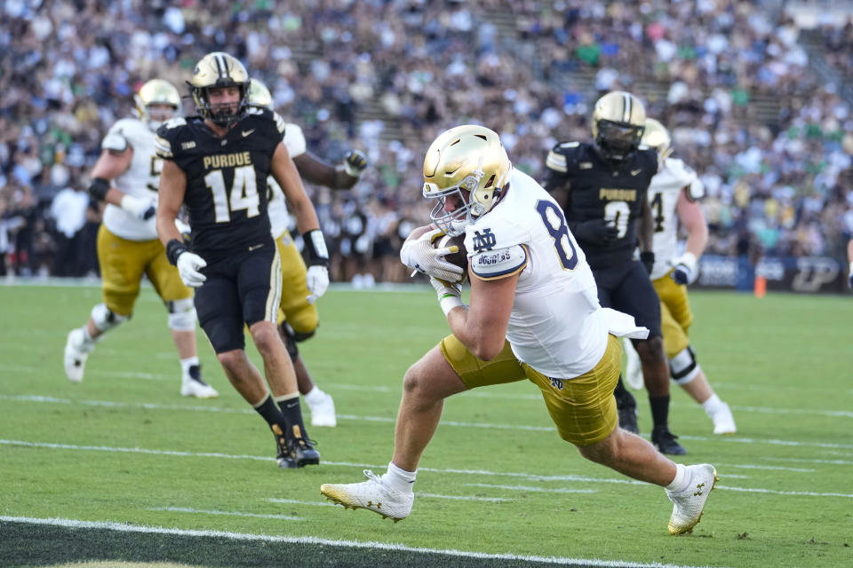 Notre Dame tight end Kevin Bauman (84) runs in for a touchdown after a catch against Purdue during the second half of an NCAA college football game in West Lafayette, Ind., Saturday, Sept. 14, 2024. (AP Photo/Michael Conroy)