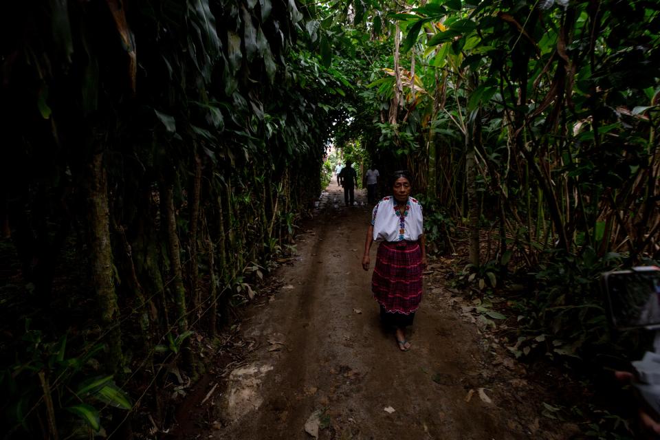 Juana Cuc walks in her Mayan village in Guatemala, where her son once walked. Marcos Abdon Tziquin Cuc left his childhood home in hopes of working in the U.S. He was detained in the outskirts of Juárez, Mexico, and transferred to a migrant detention center, where he died in a fire in March 2023.