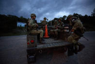 Soldiers wearing the armbands of Mexico's National Guard board a truck to patrol back roads that migrants use to avoid a migration checkpoint, north of Comitan, Chiapas State, Mexico, Saturday, June 15, 2019. Under pressure from the U.S. to slow the flow of migrants north, Mexico plans to deploy thousands of National Guard troops by Tuesday to its southern border region.(AP Photo/Rebecca Blackwell)