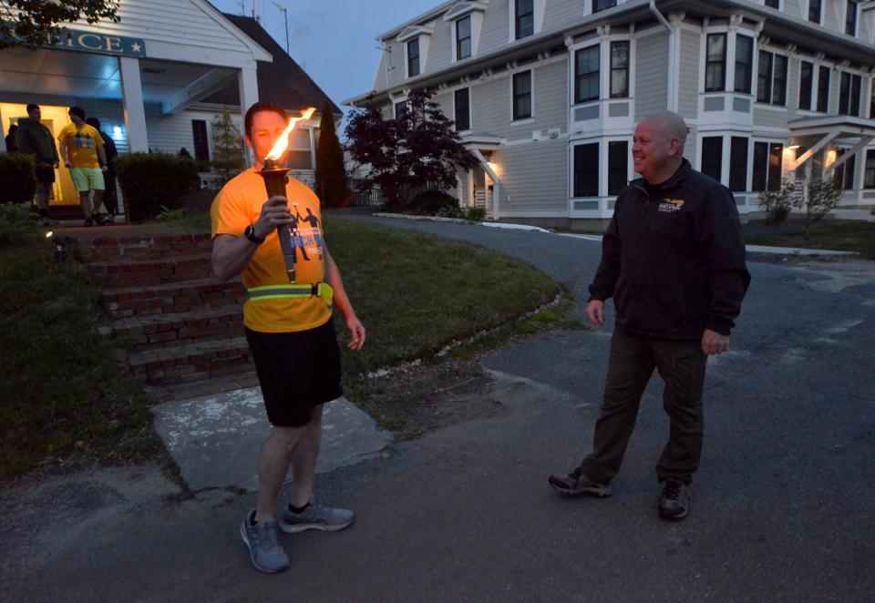 In this May 24 photo, Harwich Deputy Police Chief Kevin Considine, right, talks with Provincetown Deputy Police Chief Gregory Hennick before the start of the local torch run.