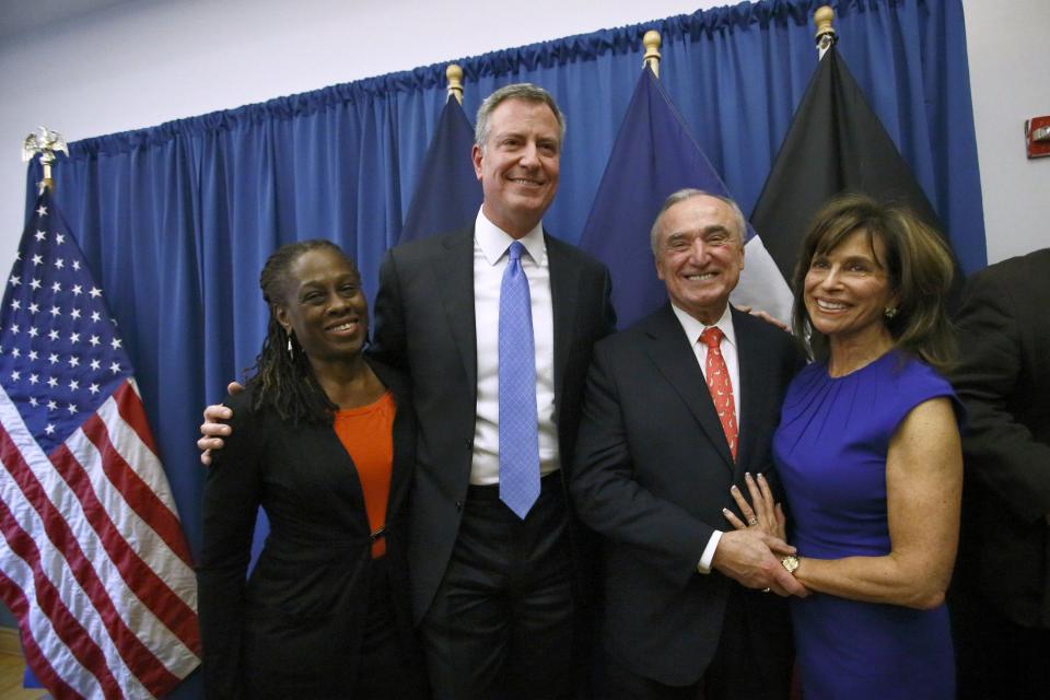 Blasio and his wife McCray, Bratton and his wife Klieman, smile as they pose for a picture after a news conference in Brooklyn