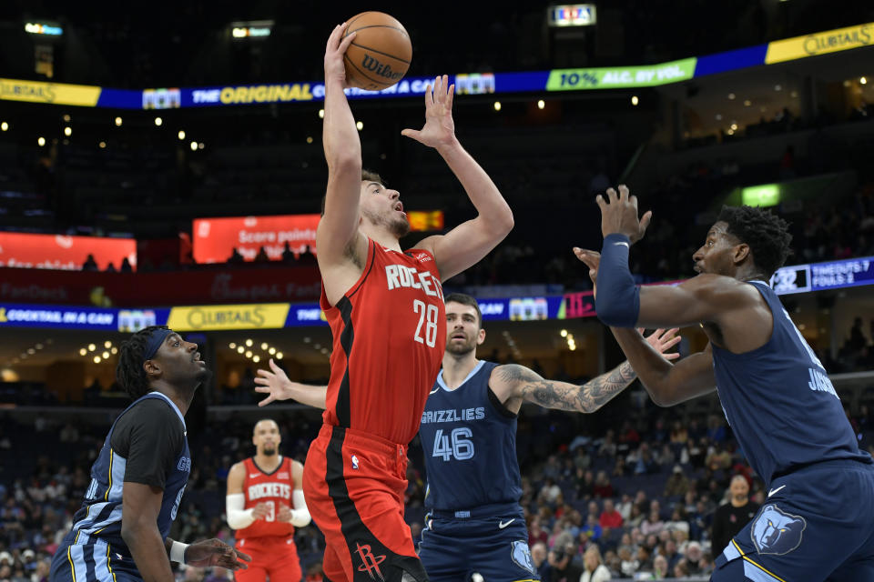 Houston Rockets center Alperen Sengun (28) shoots against Memphis Grizzlies forward Jaren Jackson Jr., right, during the first half of an NBA basketball game Wednesday, Feb. 14, 2024, in Memphis, Tenn. (AP Photo/Brandon Dill)