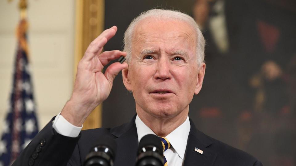 PHOTO: President Joe Biden holds a microchip as he speaks before signing an executive order on securing critical supply chains, in the State Dining Room of the White House, Feb. 24, 2021. (Saul Loeb/AFP via Getty Images)