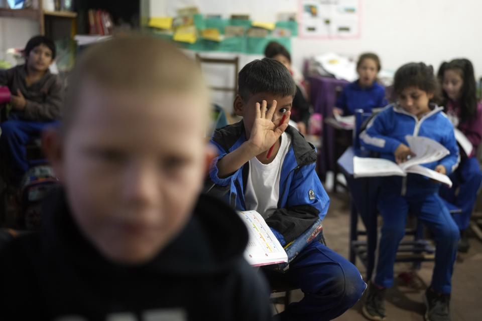 Third graders attend class inside a building at the New Asuncion school in Presidente Hayes in Paraguay's Chaco region, Monday, June 3, 2024. Due to not enough classrooms, students have been attending classes outside for the past three years with instruction from a municipal worker. (AP Photo/Jorge Saenz)