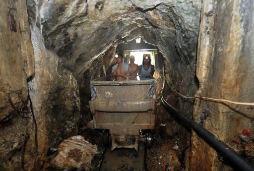 Workers inside a mine tunnel at Mount Diwata on the southern Philippine island of Mindanao. About 42,000 people live on and around the mountain, according to the village census