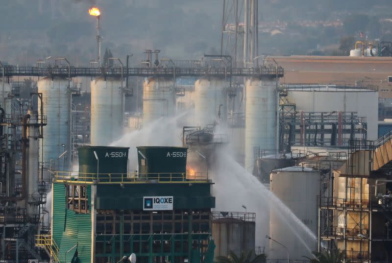 Firefighters spray water after a large fire broke out at the chemical factory, after explosion at a factory in the Tarragona