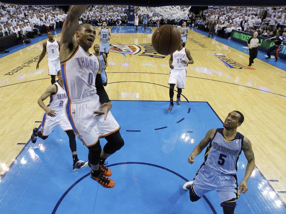 Oklahoma City Thunder guard Russell Westbrook (0) dunks in front of Memphis Grizzlies guard Courtney Lee (5) in the second quarter of Game 5 of an opening-round NBA basketball playoff series in Oklahoma City, Tuesday, April 29, 2014. (AP Photo)