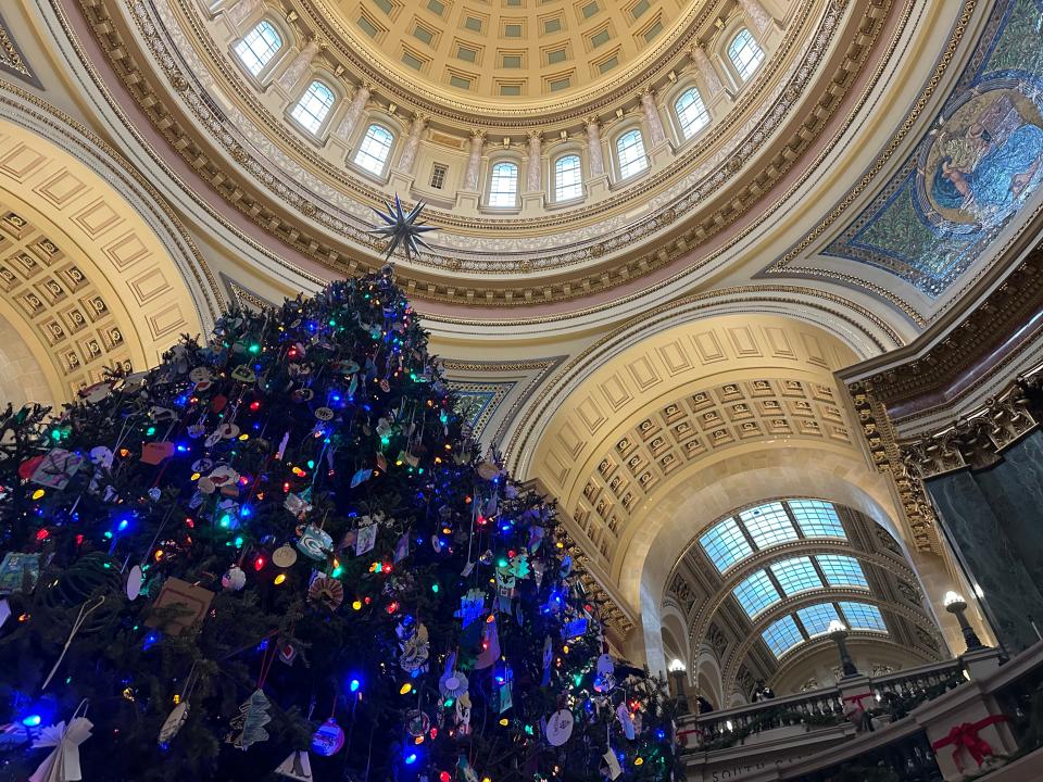 The Capitol Holiday Tree that stands in the statehouse rotunda is illuminated by more than 2,000 lights. The 32-foot, Balsam Fir, donated by Marge Van Heuklon of Rhinelander, the tree's theme commemorates the state's 175-year anniversary.