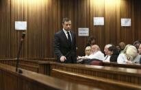 Olympic and Paralympic track star Oscar Pistorius arrives in the dock ahead of the verdict in his trial at the North Gauteng High Court in Pretoria September 12, 2014. REUTERS/Alon Skuy/Pool