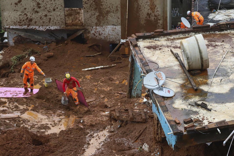 Firefighters search for victims near houses destroyed by a landslide after heavy rains in Barreiro, Minas Gerias state, Brazil, Saturday, Jan.25, 2020. The death toll caused by record rainfall in southeastern Brazil jumped on Sunday and officials expressed alarm about continuing storms. (Flavio Tavares/Futura Press via AP)