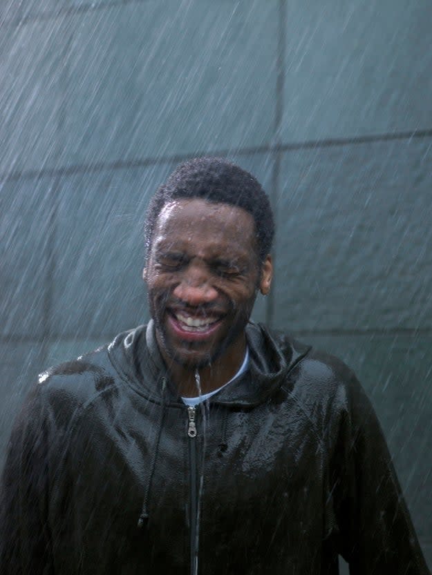 Person grimacing while standing in the rain