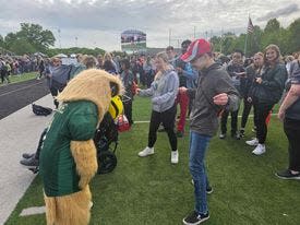 Sixteen-year-old Brock Mohr, a sophomore at GlenOak High School, has a dance off with Ernie the Eagle during the opening ceremonies of the 37th annual Exceptional Olympics at Perry High School.