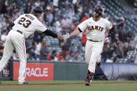 San Francisco Giants' Buster Posey is congratulated by third base coach Ron Wotus (23) after hitting a three-run home run against the Arizona Diamondbacks during the first inning of a baseball game Wednesday, June 16, 2021, in San Francisco. (AP Photo/Tony Avelar)