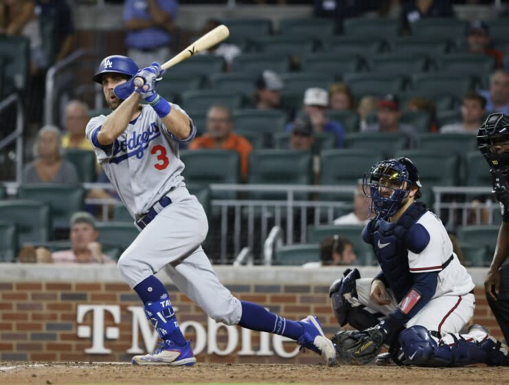 Los Angeles Dodgers' Chris Taylor hits an RBI double, scoring his team's first run during the eleventh inning.