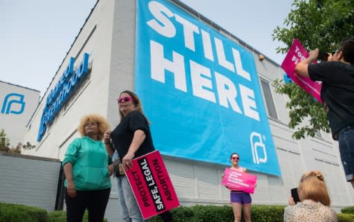 Abortion supporters stand outside the Planned Parenthood Reproductive Health Services Center in St. Louis, Missouri, on May 31, 2019, after a US Court announced the clinic, the last performing abortions in the state, could continue operating