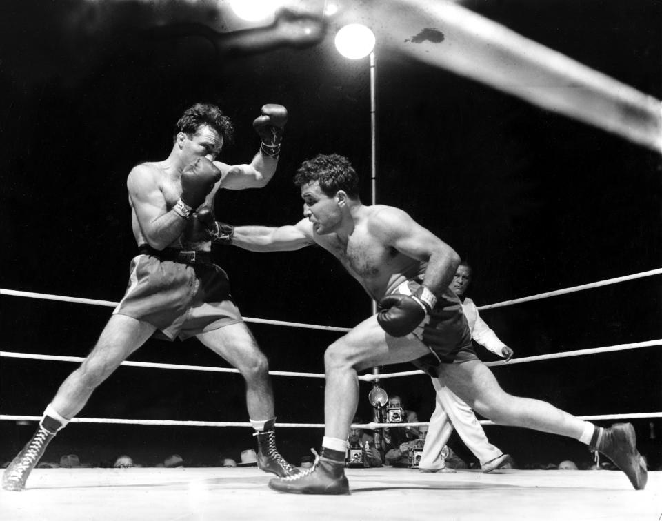 FILE - In this June 16, 1949, file photo, Jake LaMotta, right, fights Marcel Cerdan at Briggs Stadium in Detroit. LaMotta knocked out Cerdan in the 10th round to become the new world middleweight champion. The movie "Raging Bull," about the life of Jake Lamotta, was No. 7 in The Associated Press’ Top 25 favorite sports movies poll. (AP Photo/File)