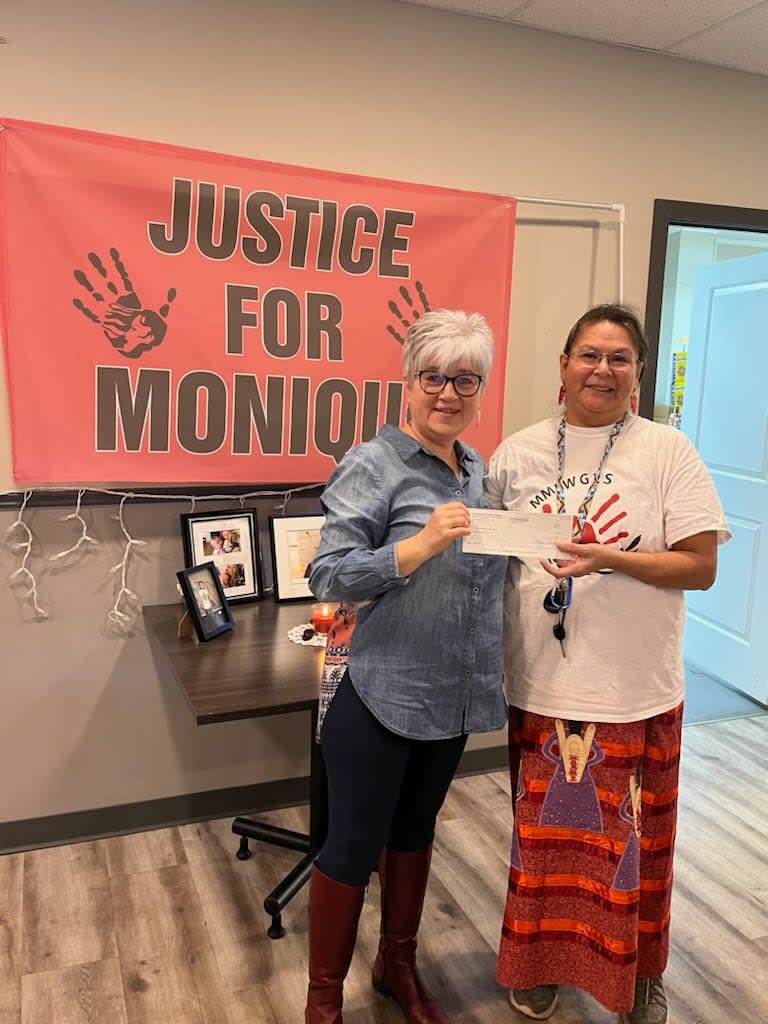 Karen Daniels, right, presented a $1,000 on Friday to Good Neighbours Food Centre executive director  Betty Rudachyk in Rosthern, Sask., on Friday. Daniels, from One Arrow First Nation, made the donation in honour of her daughter, Monique Gamble, who was killed in November 2022. (Submitted by Betty Rudachyk - image credit)