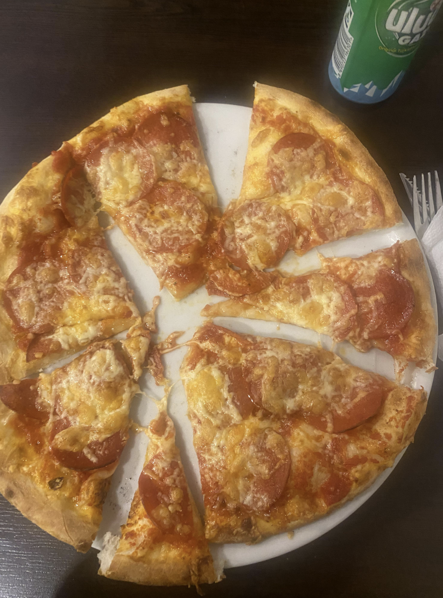 A pizza with slices cut into different shapes and sizes.