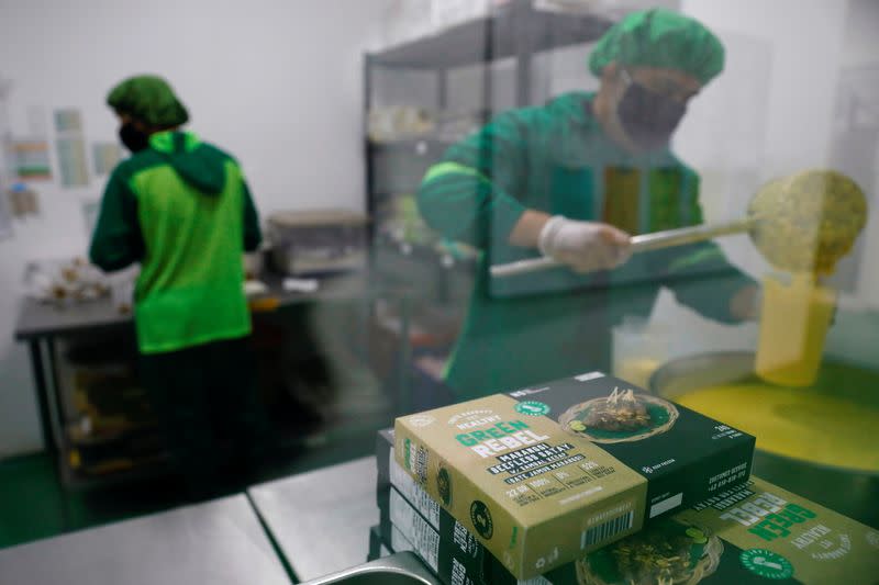 Workers prepare sauces at the kitchen of Green Rebel Foods in Serpong