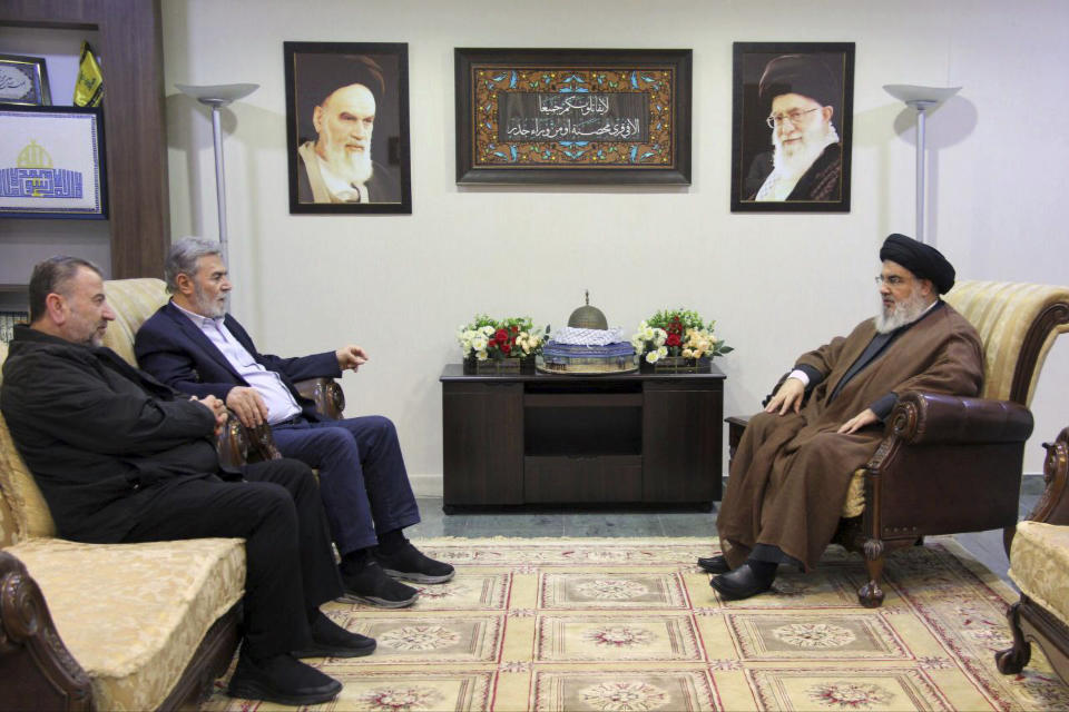 In this photo released on Wednesday, Oct. 25, 2023, by the Hezbollah Media Relations Office, Hezbollah leader Sayyed Hassan Nasrallah, right, meets with Ziad al-Nakhleh, the head of Palestinian Islamic Jihad, center, and Hamas deputy chief, Saleh al-Arouri, in Beirut, Lebanon. Nasrallah met with top Hamas and Palestinian Islamic Jihad officials, their first reported meeting since the Hamas-Israel war erupted earlier this month and clashes began along the Lebanon-Israel border. (Hezbollah Media Relations Office, via AP )