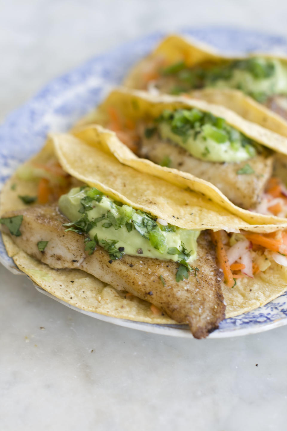 This June 3, 2013 photo taken in Concord, N.H. shows a recipe for healthy fish tacos with avocado. (AP Photo/Matthew Mead)