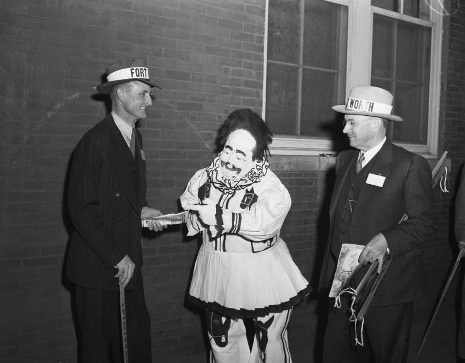 Feb. 4, 1942: Southwestern Exposition and Fat Stock Show. Harrell C. Ashburn, left, and B. H. Glenn, right, shown with Bobo, the clown.