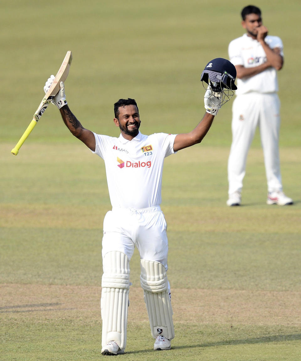 Sri Lanka batsman Dimuth Karunaratne celebrates scoring his double century during the fourth day of the first test cricket match between Sri Lanka and Bangladesh in Pallekele, Sri Lanka, Saturday, April 24, 2021.( AP Photo/Sameera Peiris)