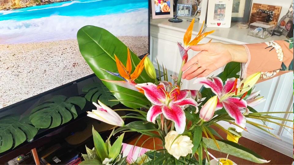 Flowers, especially faux ones, are an affordable way to design a tropical staycation at home. (Photo: Yahoo Life)