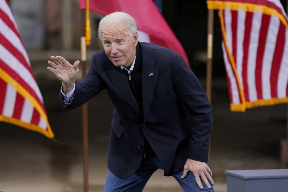 President-elect Joe Biden waves to supporters after speaking at a drive-in rally for Georgia Democratic candidates for U.S. Senate Raphael Warnock and Jon Ossoff, Tuesday, Dec. 15, 2020, in Atlanta. (AP Photo/Patrick Semansky)